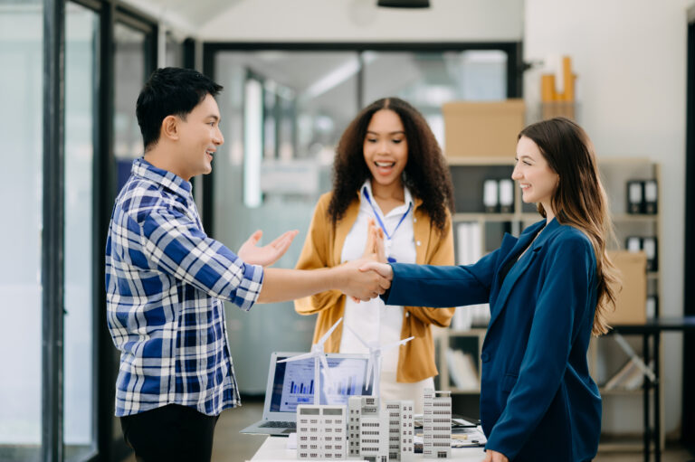 business people shaking hands during a meeting in modern office